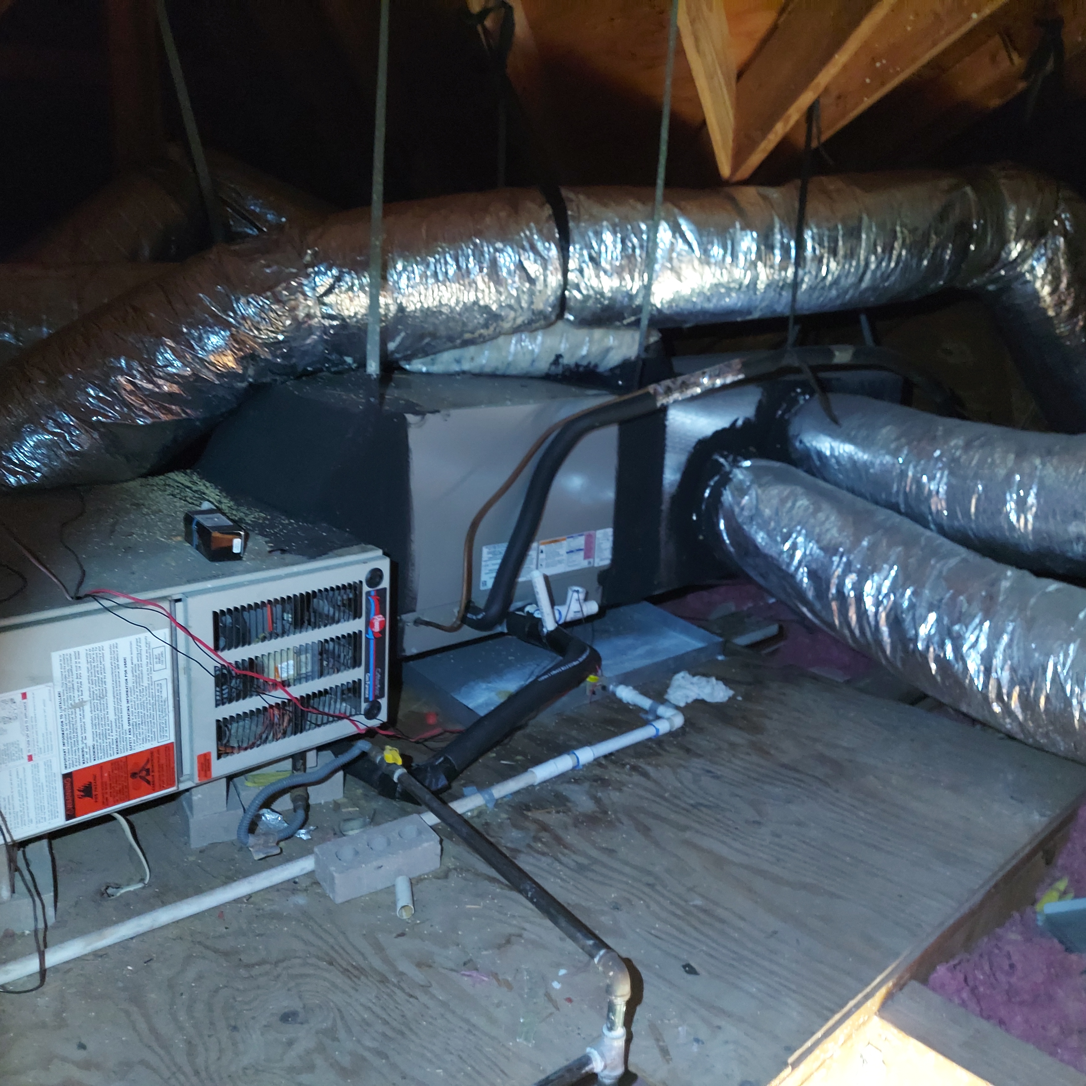 HVAC equipment and ductwork in an attic.